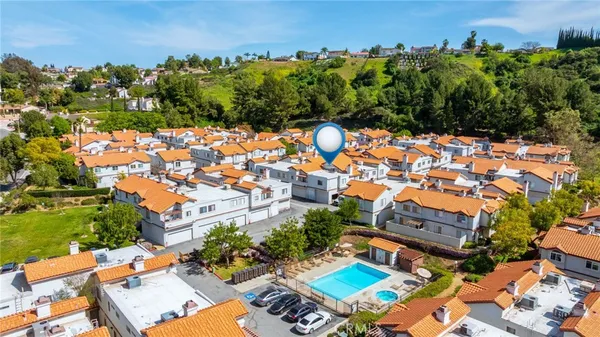 an aerial view of residential houses with outdoor space