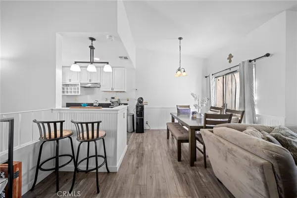a kitchen with granite countertop a sink a stove and wooden cabinets