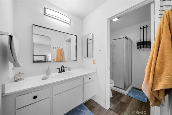a bathroom with a double vanity sink mirror and shower