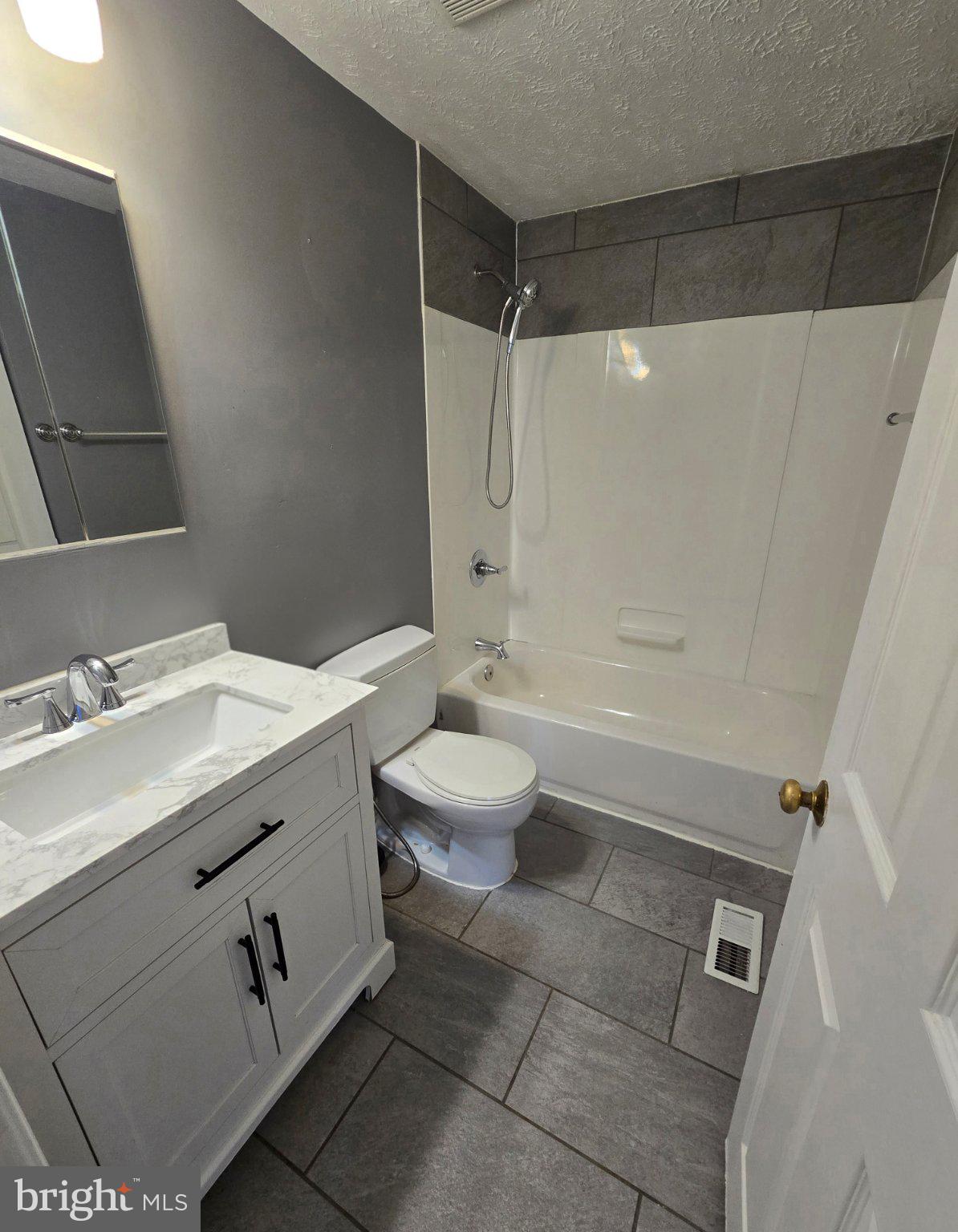5040 Clifford Road, Unit 5040 Perry Hall, MD 21128 - Photo 12 of 19 a bathroom with a sink a toilet and shower