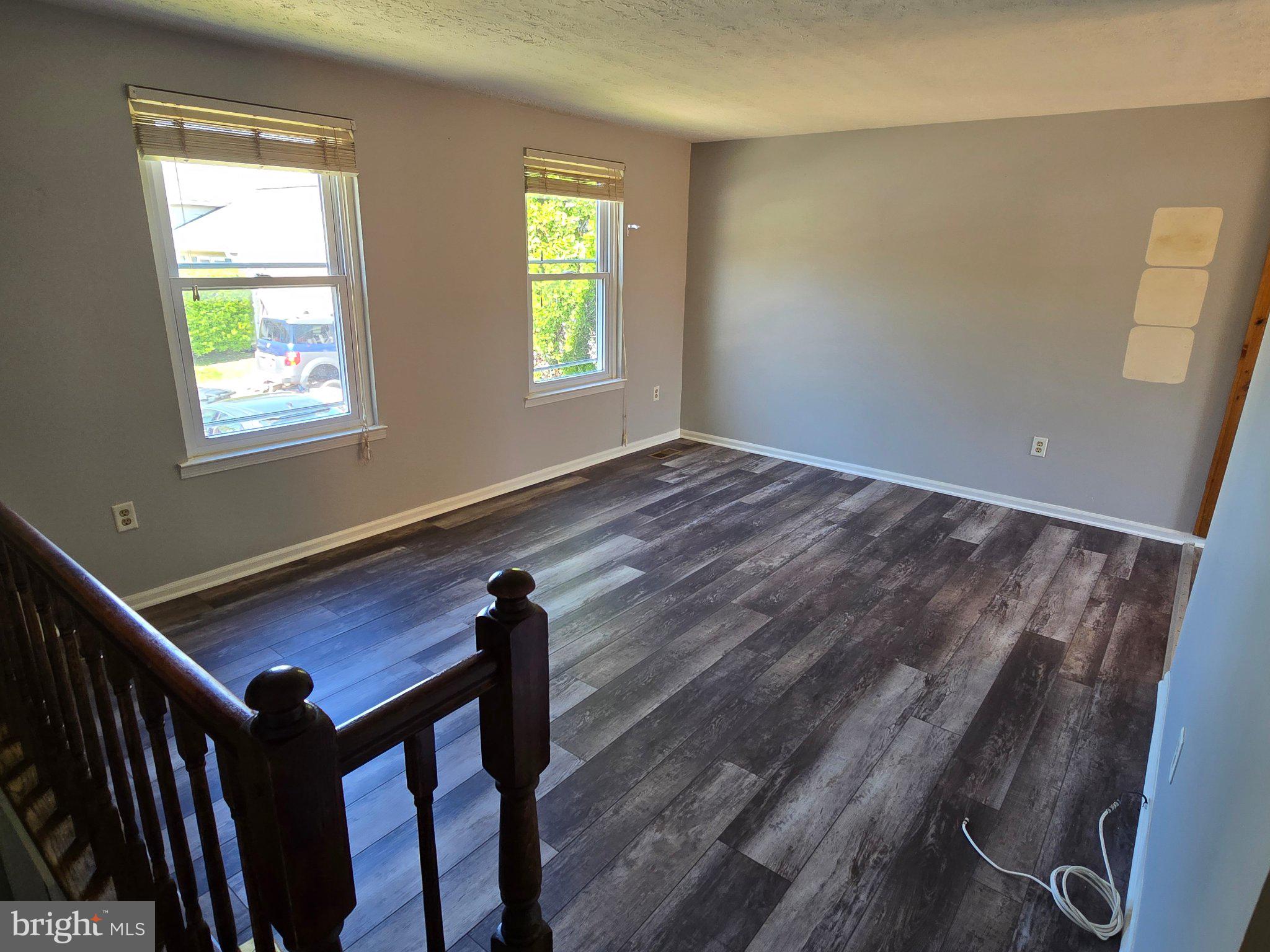 5040 Clifford Road, Unit 5040 Perry Hall, MD 21128 - Photo 4 of 19 a view of an empty room with wooden floor and a window