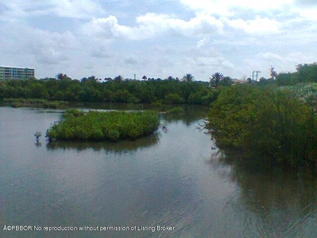 2195 Ibis Isle Road, Unit 5 Palm Beach, FL 33480 - Photo 4 of 12 a view of a lake from a yard