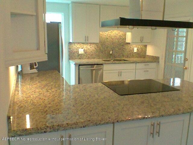 2195 Ibis Isle Road, Unit 5 Palm Beach, FL 33480 - Photo 7 of 12 a bathroom with a granite countertop sink and a mirror