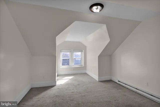 a view of an empty room and a window