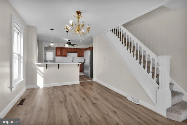 a view of a room with wooden floor and staircase