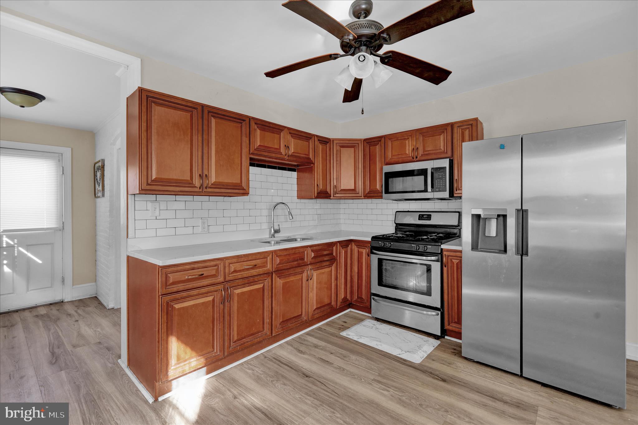 715 Mount Laurel Road Temple, PA 19560 - Photo 8 of 24 a kitchen with stainless steel appliances granite countertop a refrigerator a stove microwave and island