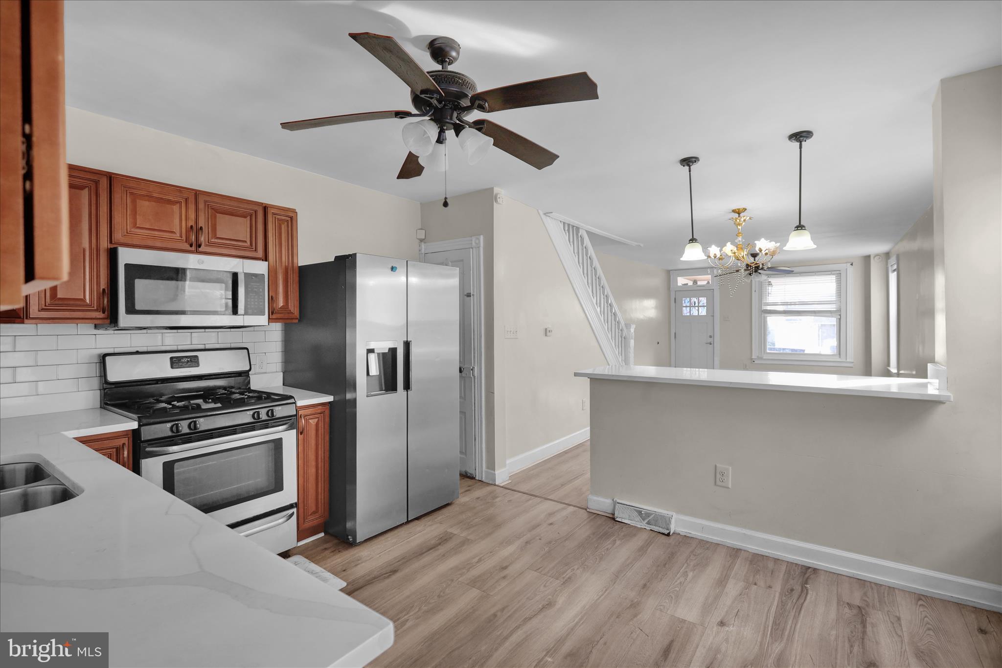 715 Mount Laurel Road Temple, PA 19560 - Photo 9 of 24 a kitchen with kitchen island white cabinets and stainless steel appliances