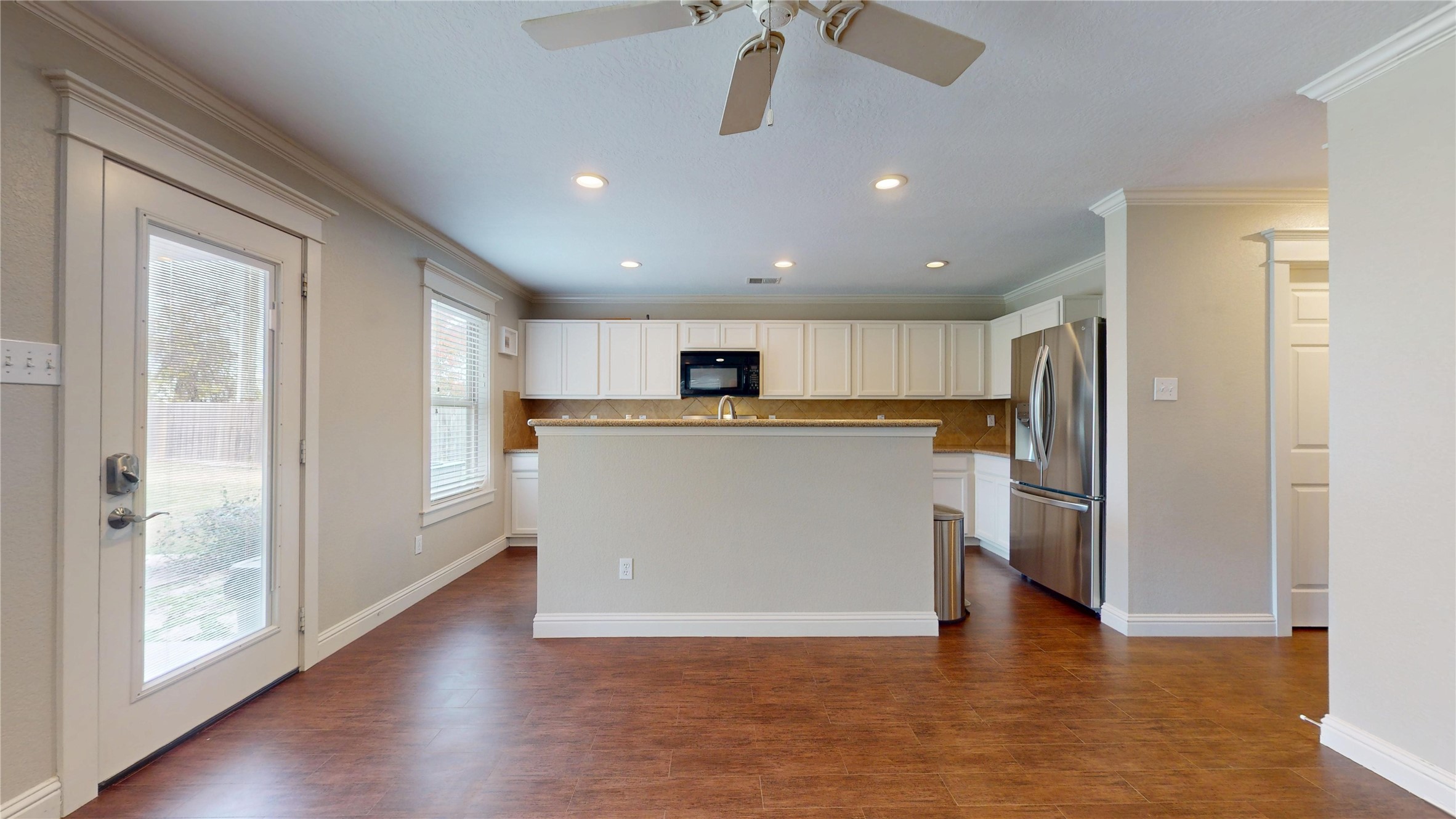 7918 Tupper Bend Court Cypress, TX 77433 - Photo 11 of 49 a view of a kitchen with a refrigerator wooden floor and a kitchen