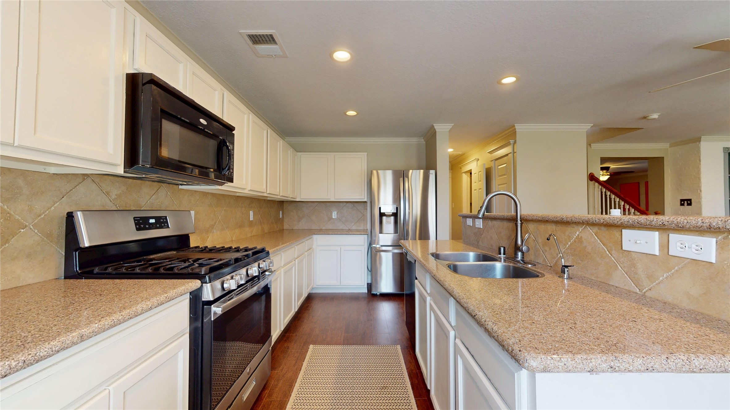 7918 Tupper Bend Court Cypress, TX 77433 - Photo 13 of 49 a kitchen with stainless steel appliances granite countertop a sink stove and refrigerator