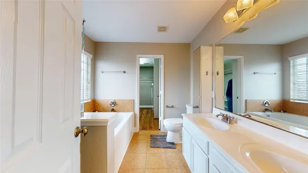 a bathroom with a tub and a window