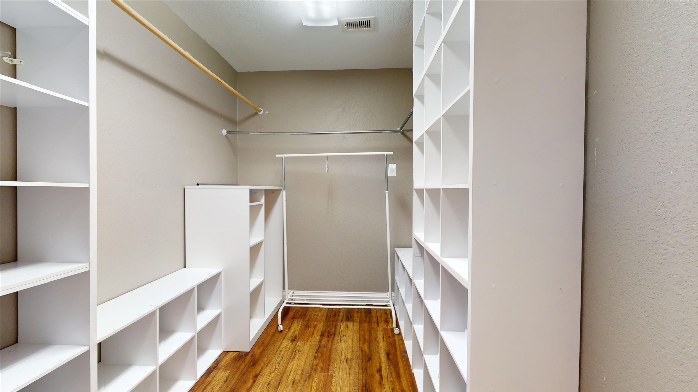 7918 Tupper Bend Court Cypress, TX 77433 - Photo 32 of 49 a view of walk in closet with wooden floor and a window