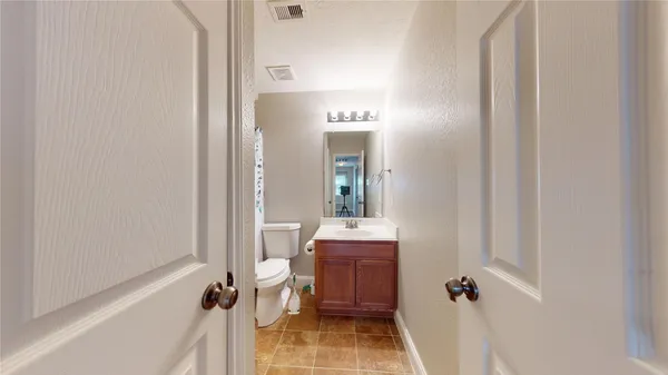a bathroom with a toilet and shower