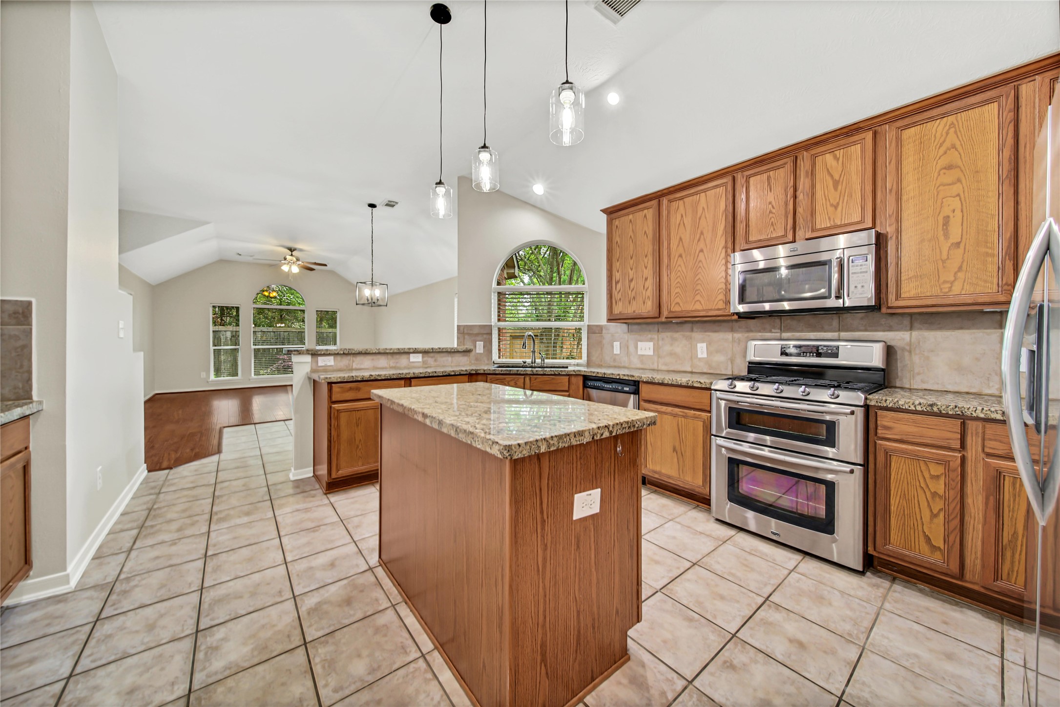14526 Red Tailed Hawk Lane Houston, TX 77044 - Photo 11 of 40 a kitchen with stainless steel appliances granite countertop a stove a sink and a microwave