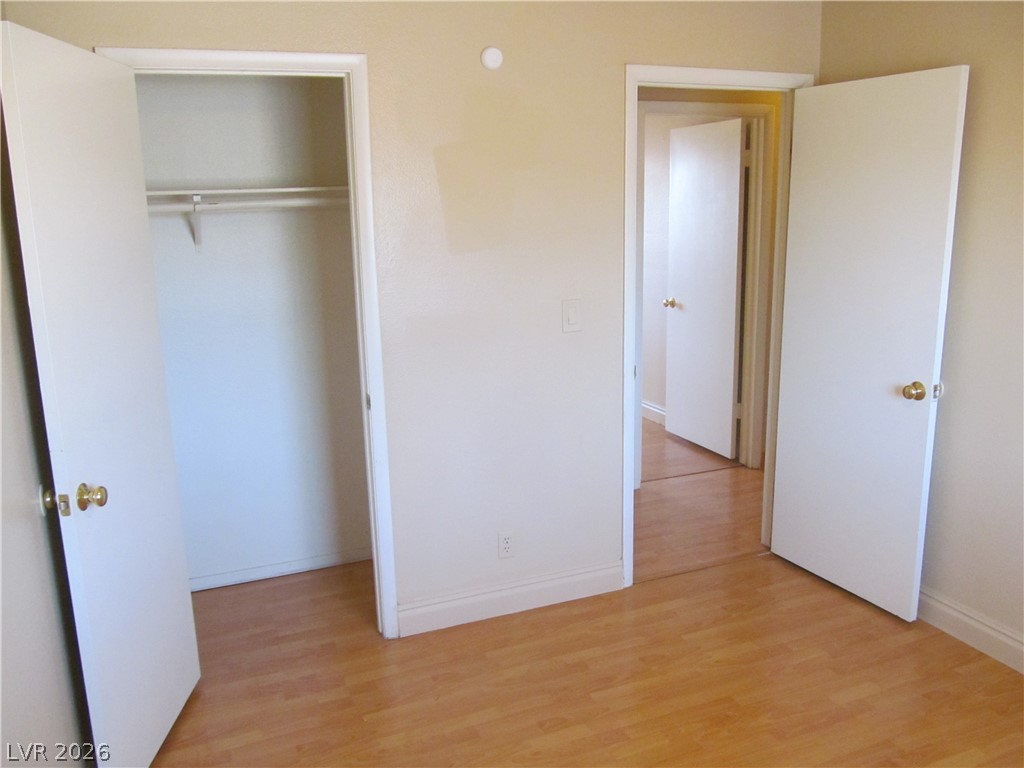 537 Longtree Avenue Henderson, NV 89011 - Photo 23 of 31 This spacious bedroom offers abundant natural light and warm hardwood flooring, ready for your personal touch.