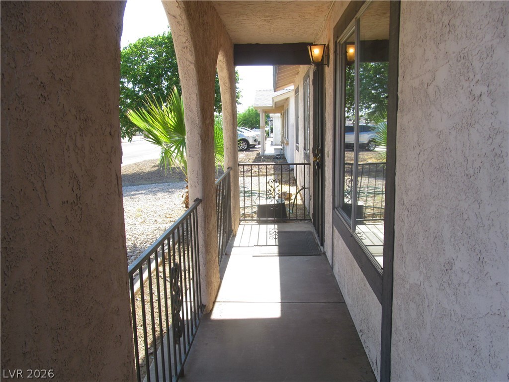 537 Longtree Avenue Henderson, NV 89011 - Photo 3 of 31 Welcome home to a charming exterior featuring a covered porch and elegant wrought iron railings.