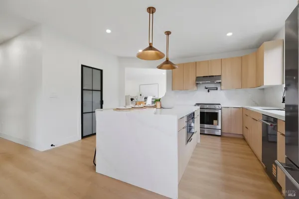 a kitchen with cabinets a sink and wooden floor