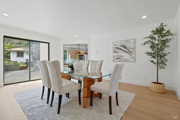 a dining room with furniture and wooden floor