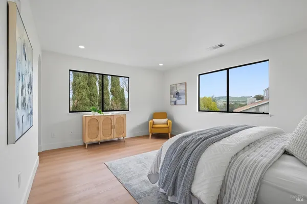 a bedroom with a large bed and a window