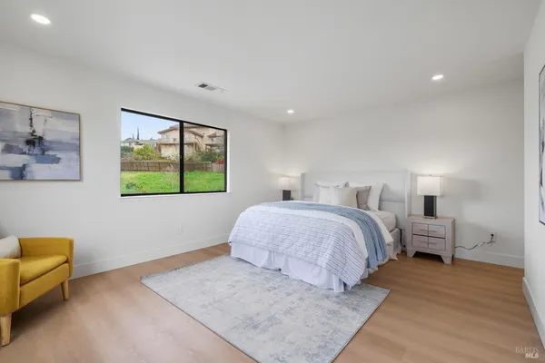a bedroom with a bed and a couch
