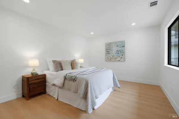 a bed room with a bed and a night stand