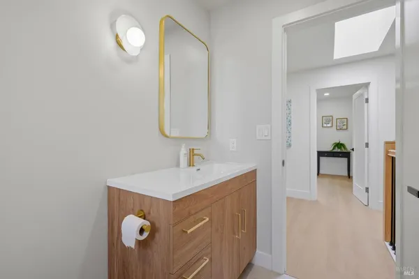 a bathroom with a sink a mirror and vanity