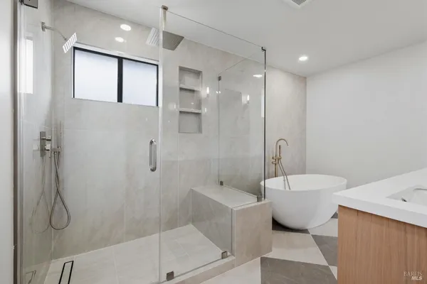 a spacious bathroom with a toilet a sink and shower