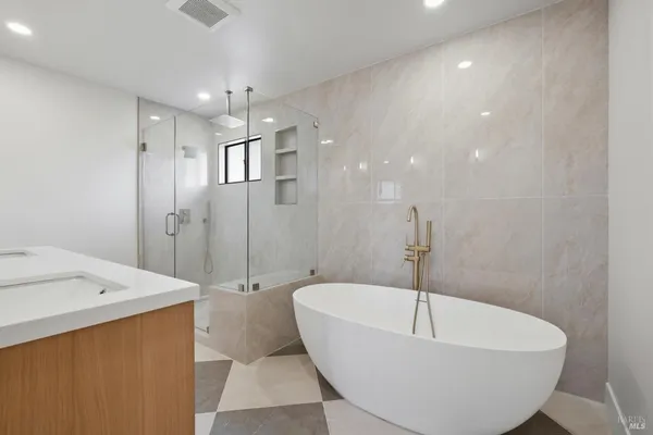 a bathroom with a bathtub and shower