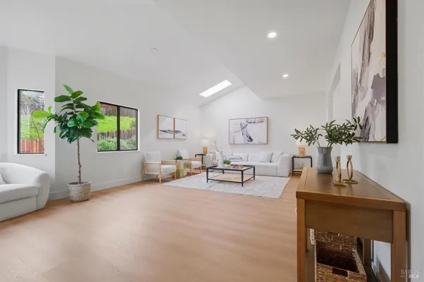 a living room with furniture and a potted plant