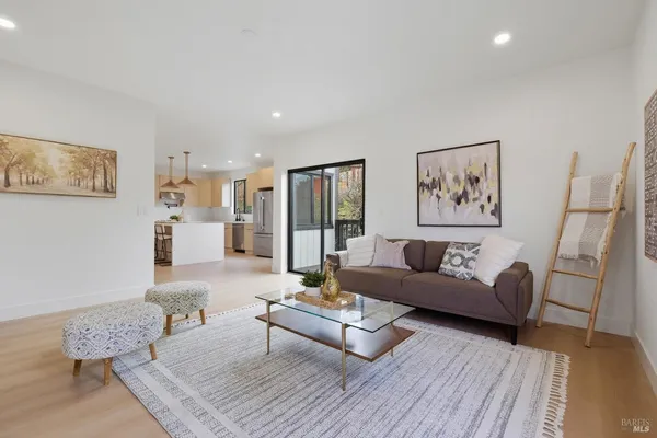 a living room with furniture and a wooden floor