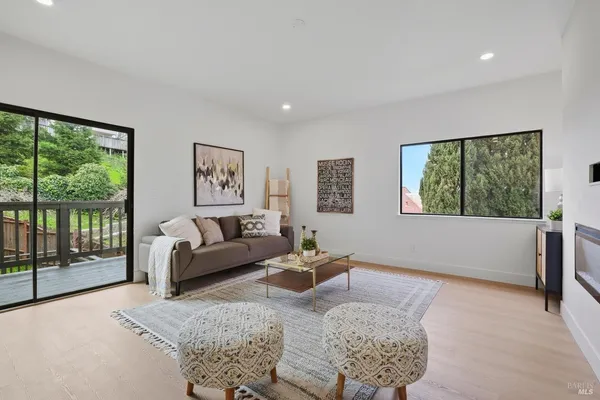 a living room with furniture and large window