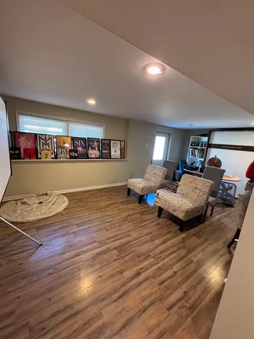 a living room with furniture and hard wood flooring