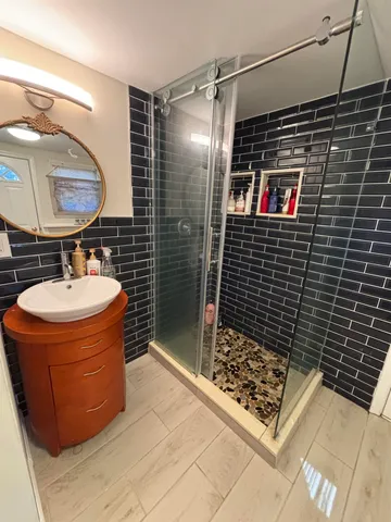 a bathroom with a sink a toilet and shower