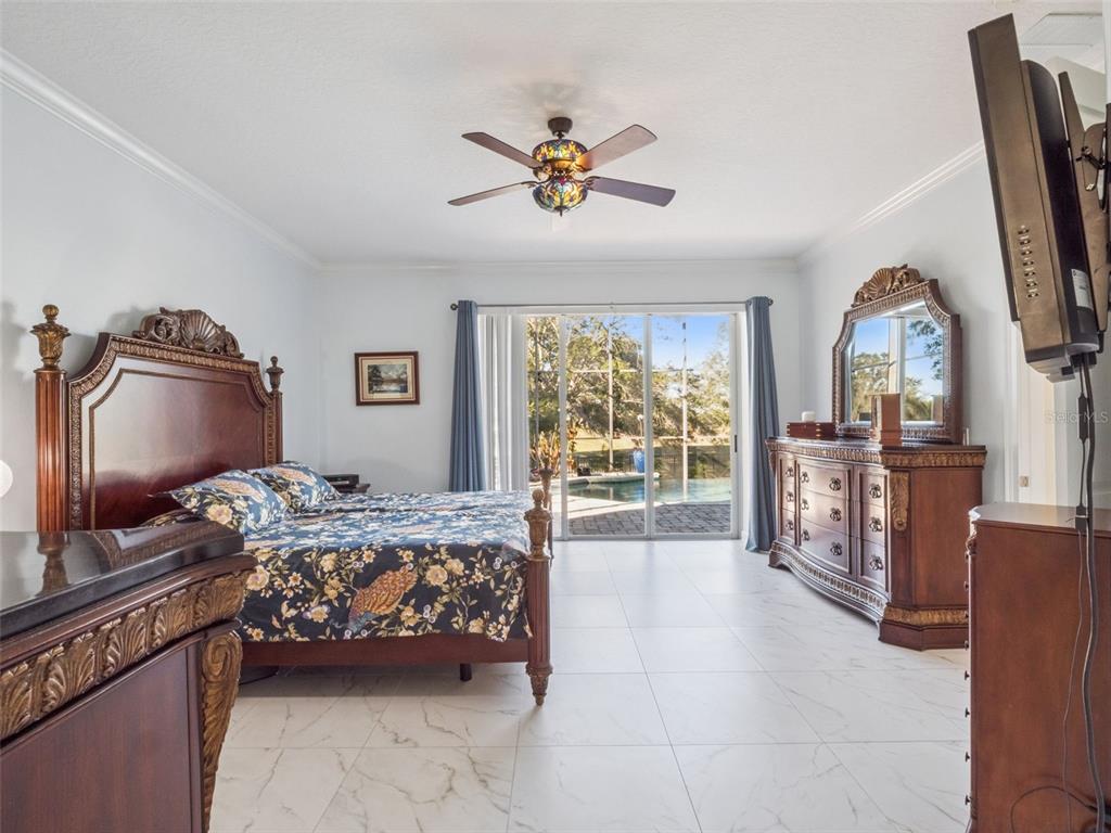 2500 St Ignatius Court Orlando, FL 32835 - Photo 27 of 71 a bedroom with a bed and a flat tv screen on dresser