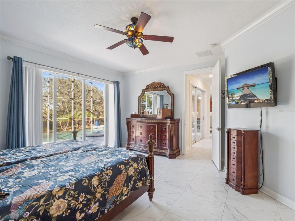 2500 St Ignatius Court Orlando, FL 32835 - Photo 29 of 71 a bedroom with a bed a dresser and flat screen tv