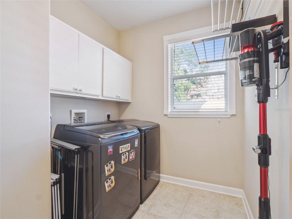 2500 St Ignatius Court Orlando, FL 32835 - Photo 30 of 71 a view of storage and utility room with washer and dryer