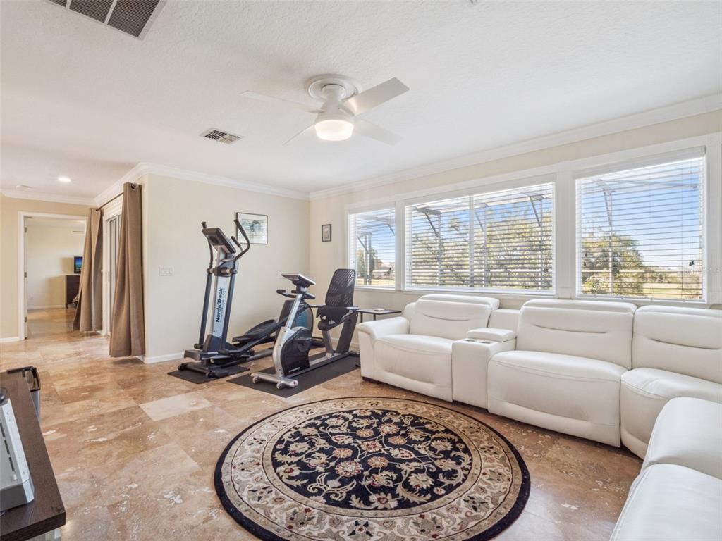 2500 St Ignatius Court Orlando, FL 32835 - Photo 39 of 71 a living room with furniture gym equipment and a large window