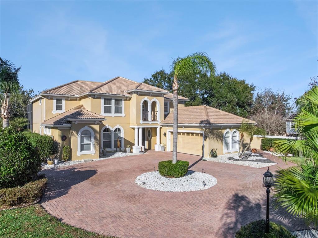 2500 St Ignatius Court Orlando, FL 32835 - Photo 60 of 71 a front view of a house with a yard and garage