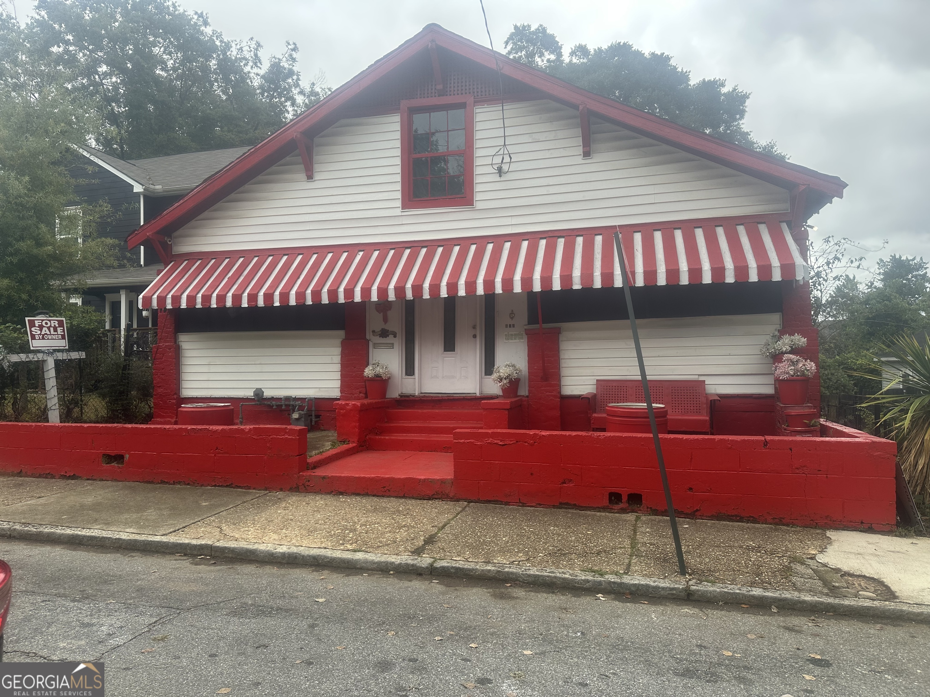 a view of a house with a patio and a yard