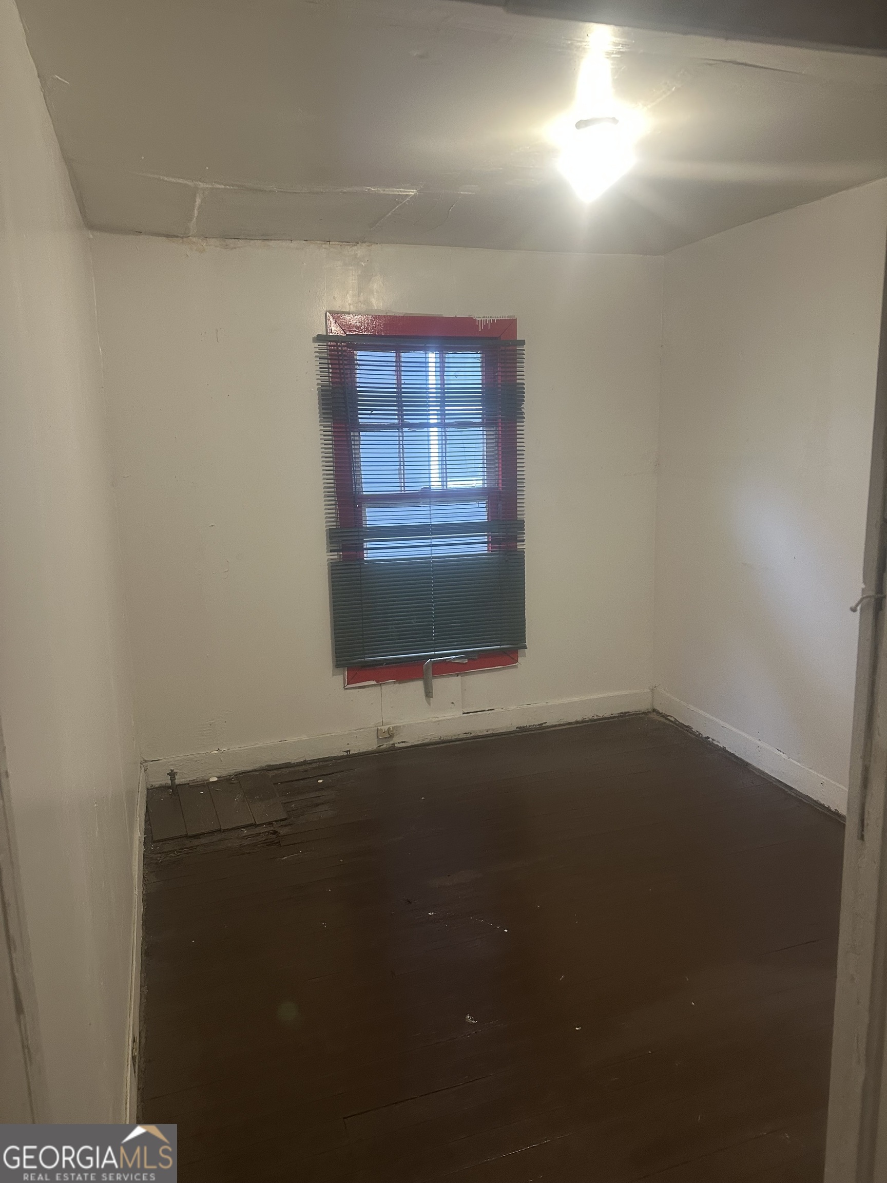 814 Welch Street Southwest Atlanta, GA 30310 - Photo 4 of 14 an empty room with wooden floor and windows