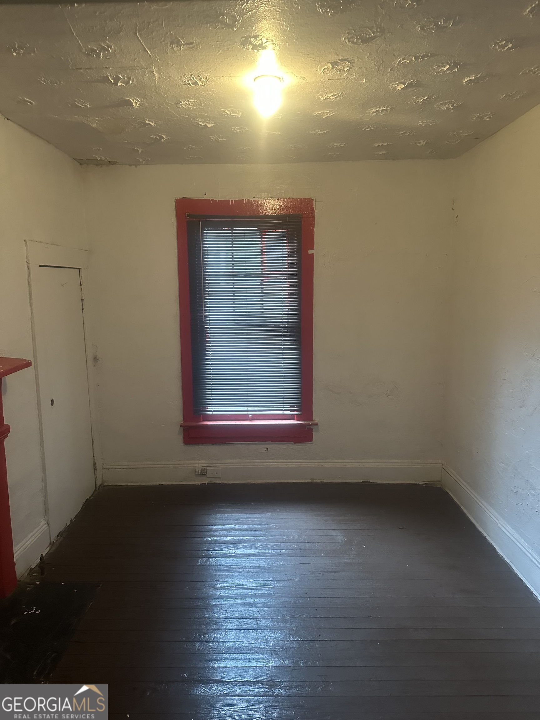 814 Welch Street Southwest Atlanta, GA 30310 - Photo 5 of 14 an empty room with wooden floor and windows