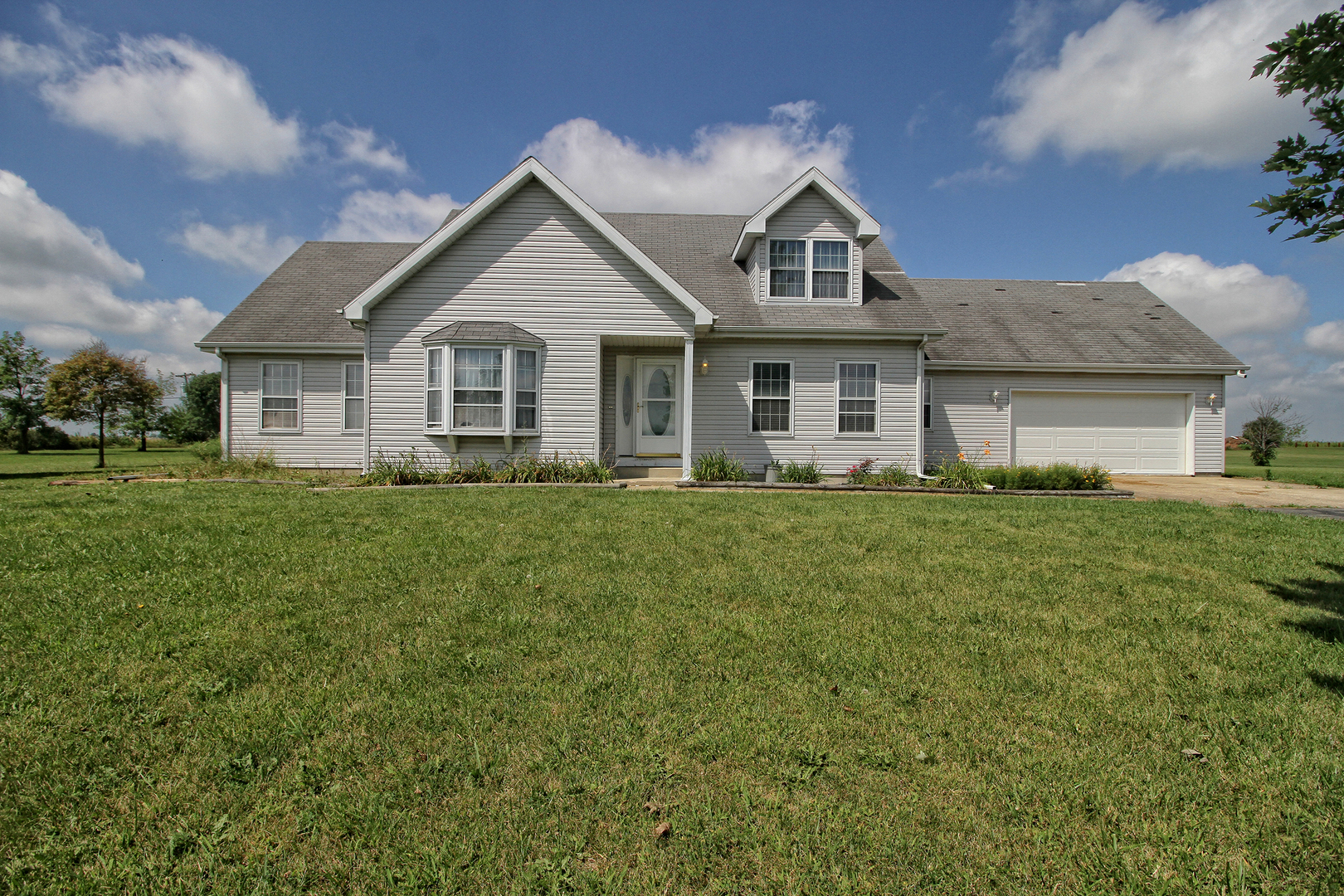 2938 South 5000W Road Kankakee, IL 60901 - Photo 1 of 18 a front view of a house with a yard and trees
