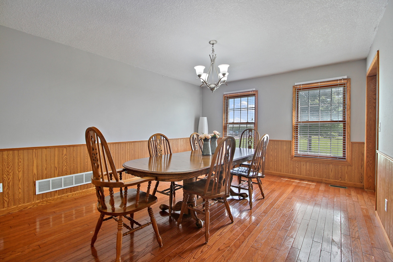 2938 South 5000W Road Kankakee, IL 60901 - Photo 3 of 18 a view of a dining room with furniture and wooden floor