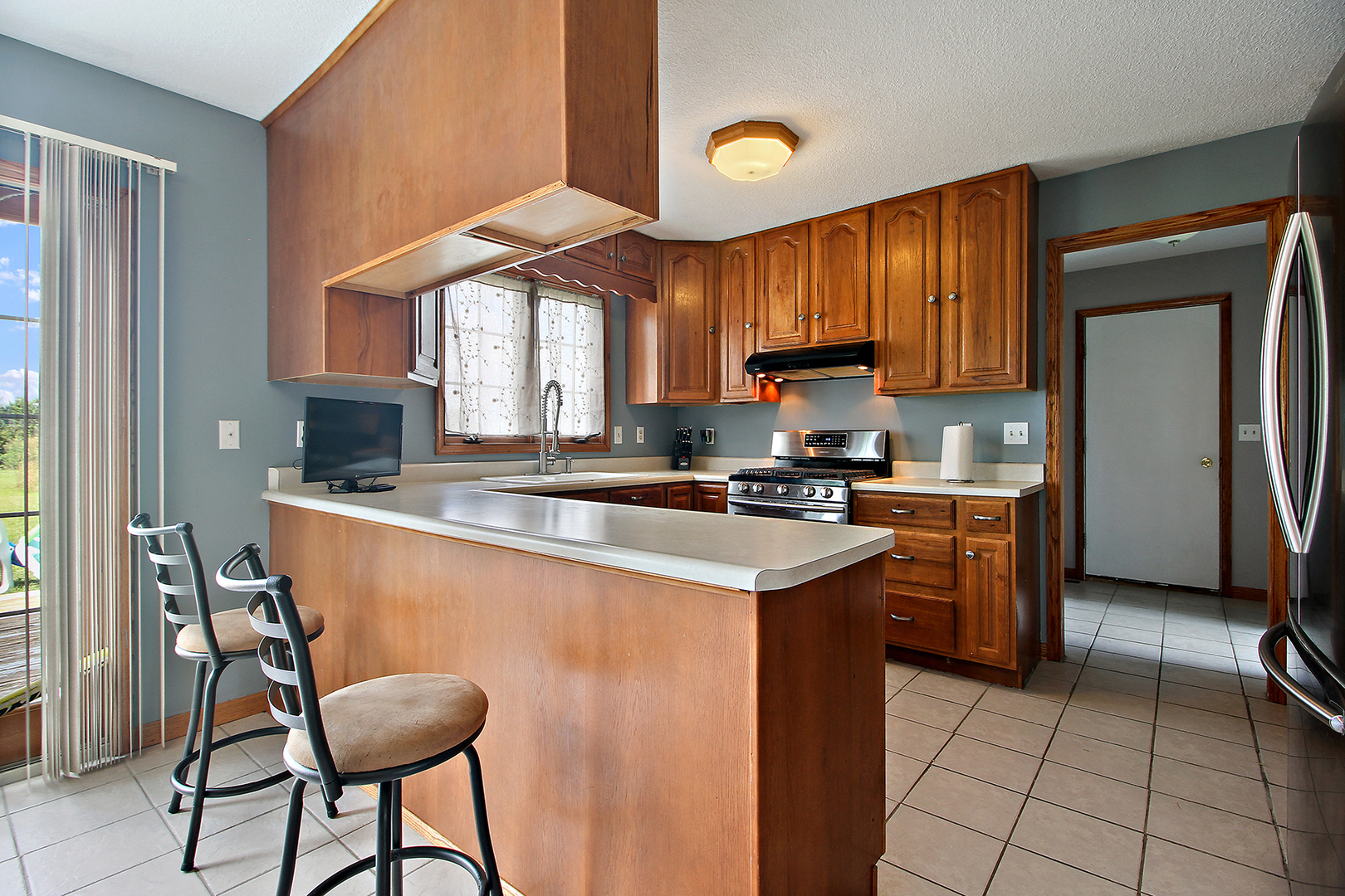 2938 South 5000W Road Kankakee, IL 60901 - Photo 4 of 18 a kitchen with stainless steel appliances granite countertop a stove a sink and a refrigerator