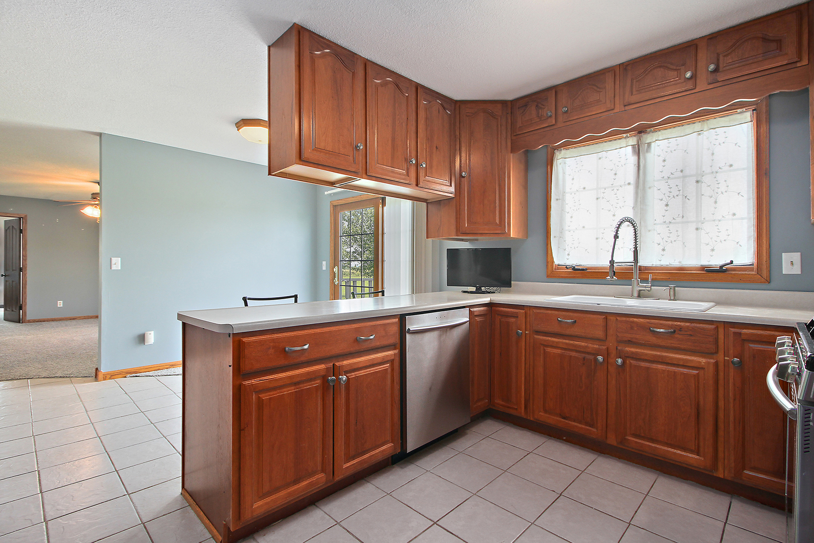 2938 South 5000W Road Kankakee, IL 60901 - Photo 5 of 18 a kitchen with stainless steel appliances granite countertop a sink stove and cabinets