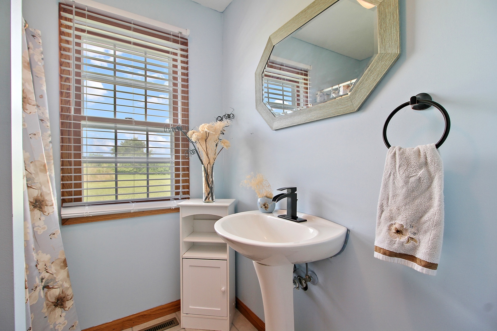 2938 South 5000W Road Kankakee, IL 60901 - Photo 8 of 18 a bathroom with a sink and a mirror