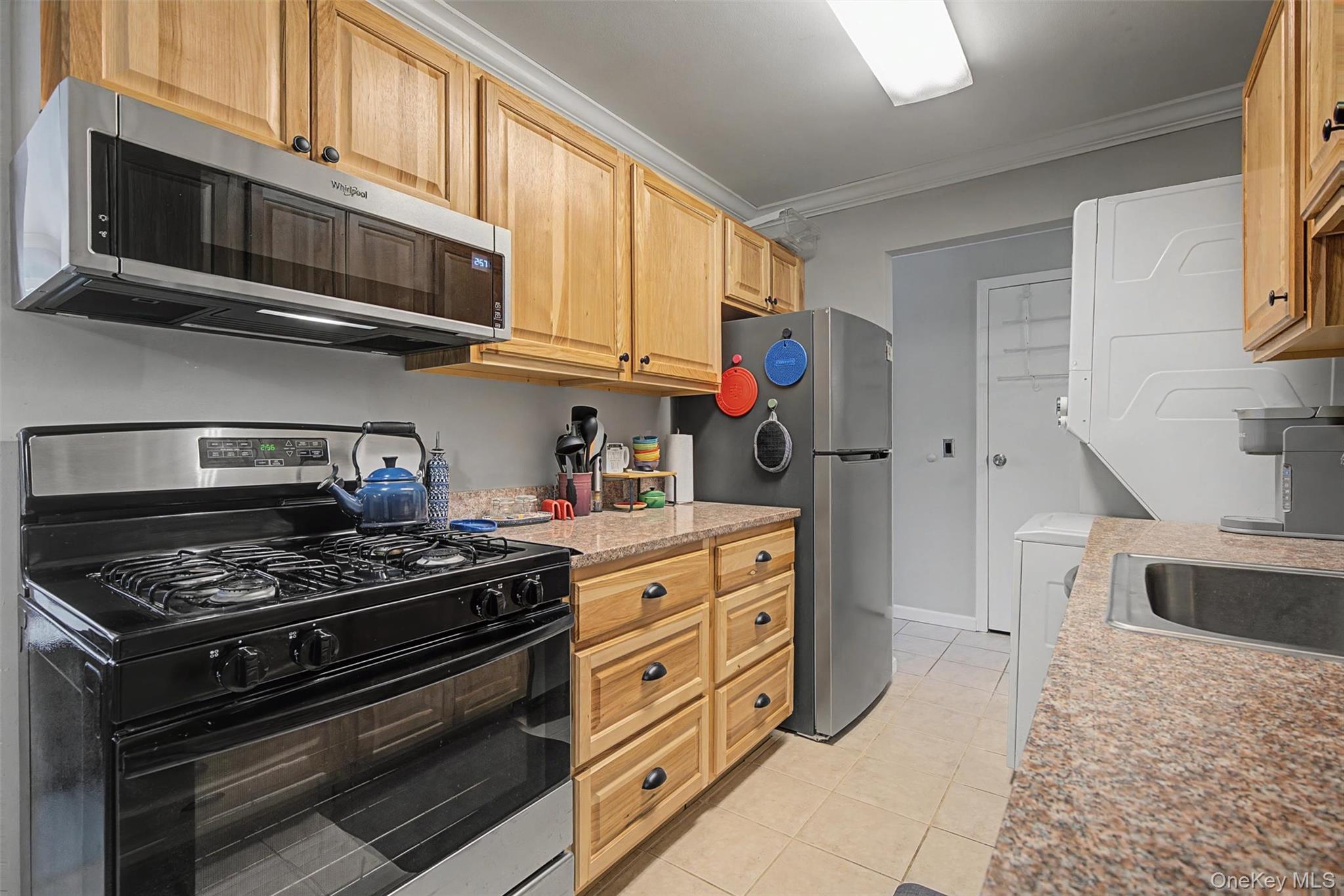 276 Temple Hill Road, Unit 1117 New Windsor, NY 12553 - Photo 13 of 24 a kitchen with stainless steel appliances granite countertop a stove and a microwave
