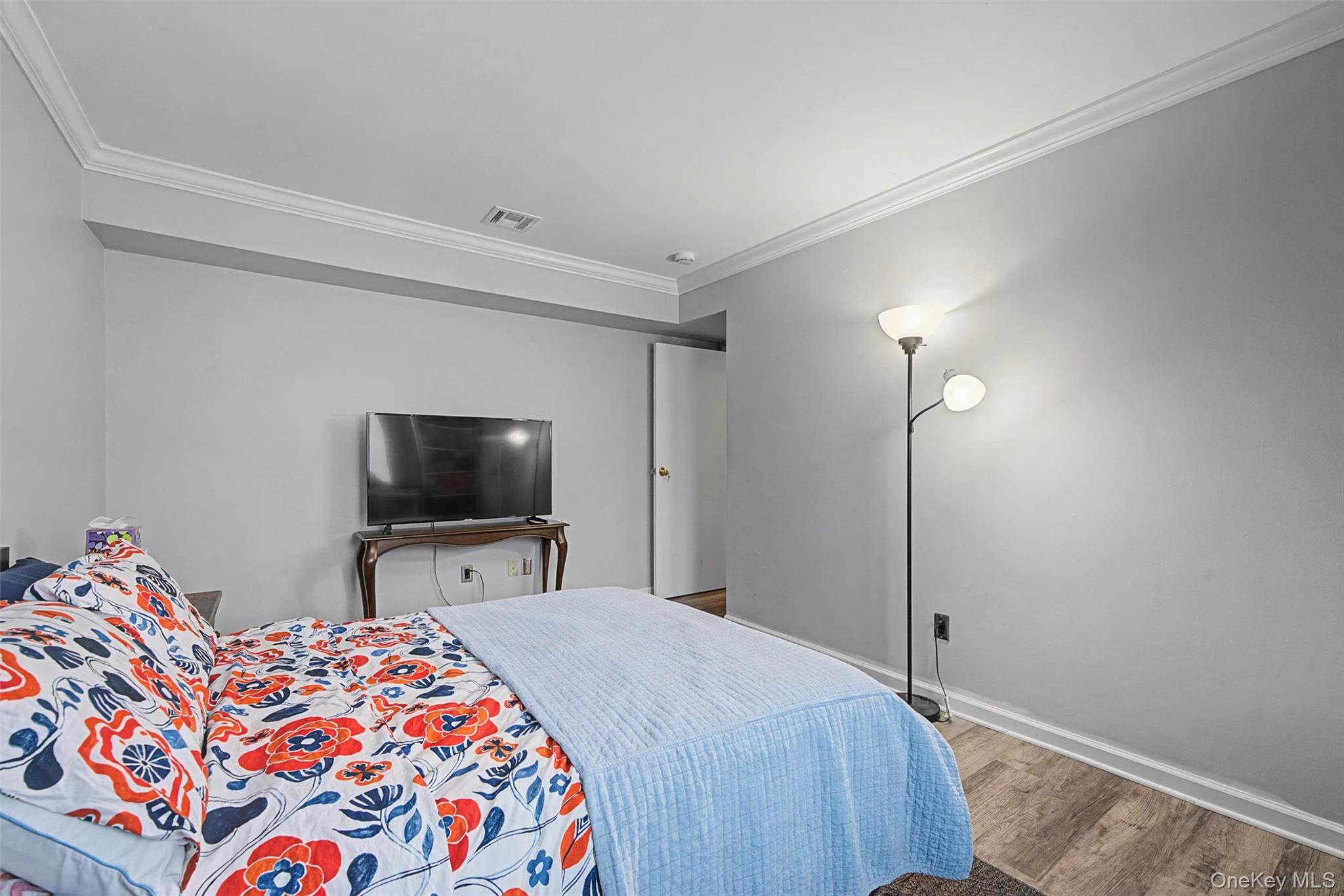 276 Temple Hill Road, Unit 1117 New Windsor, NY 12553 - Photo 18 of 24 a bedroom with a bed and a flat screen tv