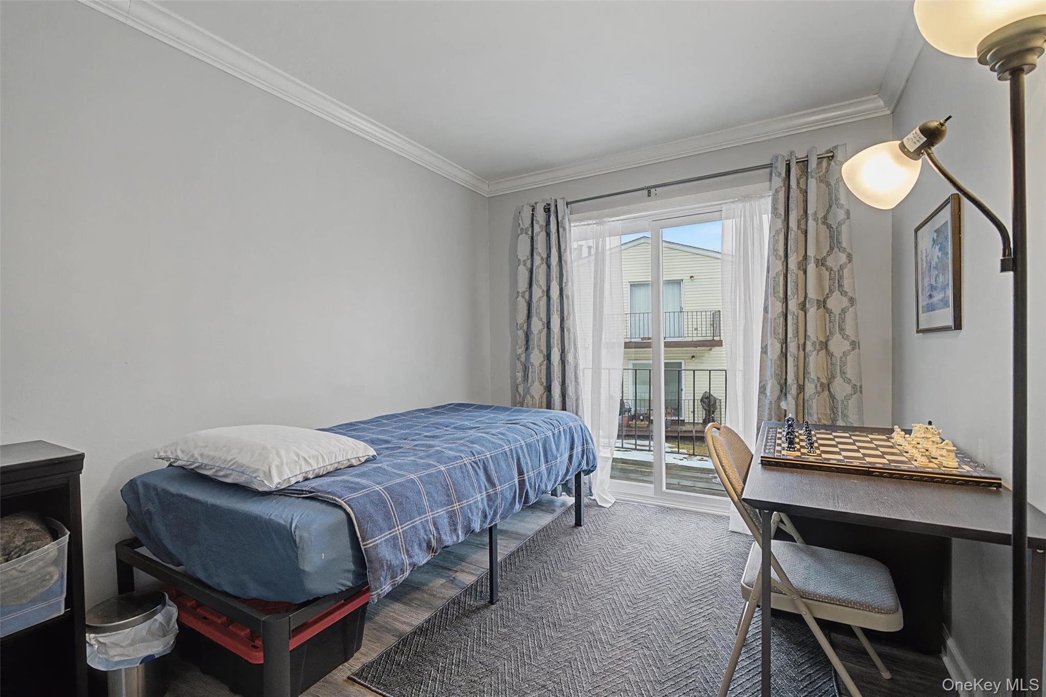 276 Temple Hill Road, Unit 1117 New Windsor, NY 12553 - Photo 20 of 24 a bedroom with a bed and a table in it