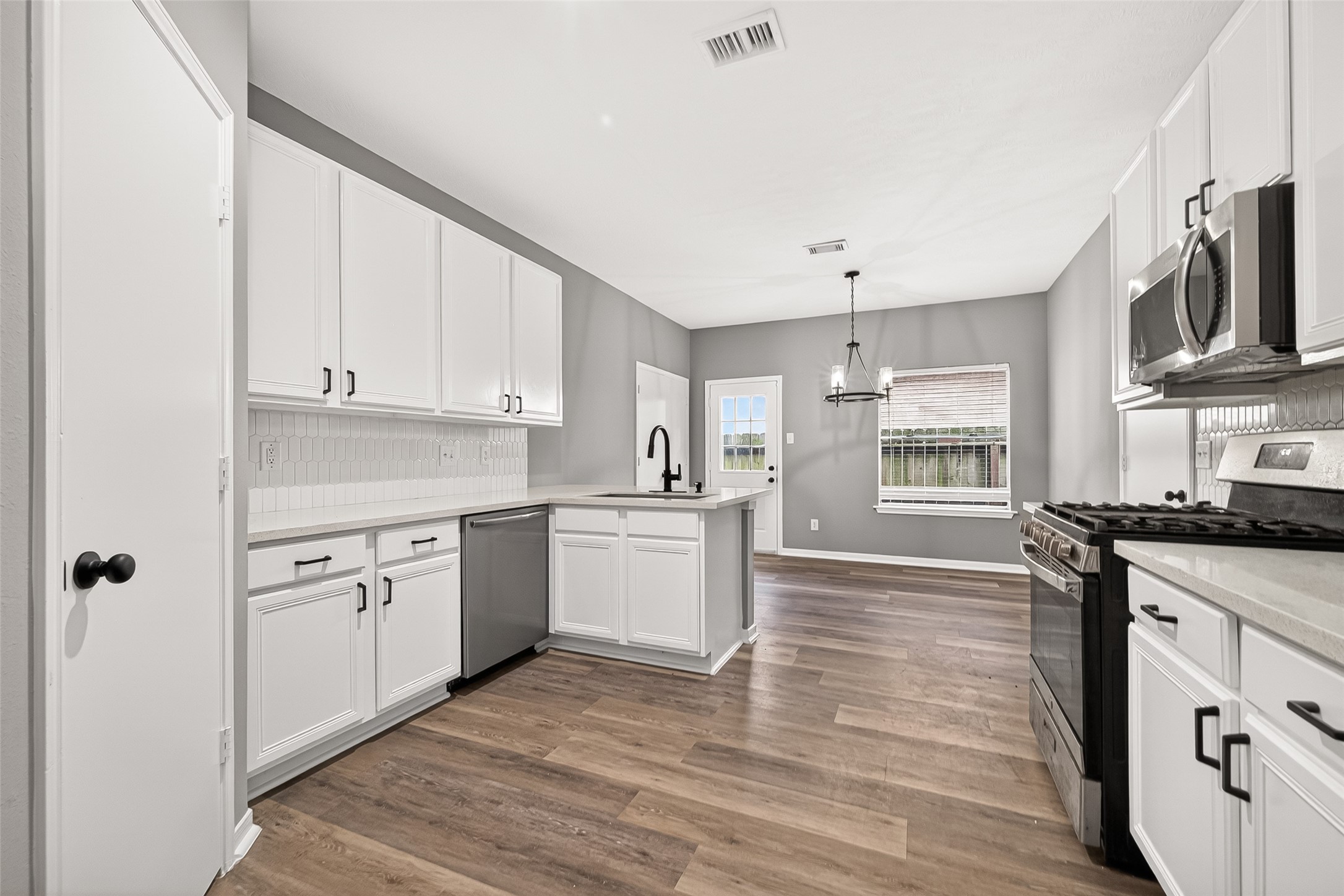 23810 Spring Way Drive Spring, TX 77373 - Photo 6 of 35 a kitchen with stainless steel appliances granite countertop a stove and a sink
