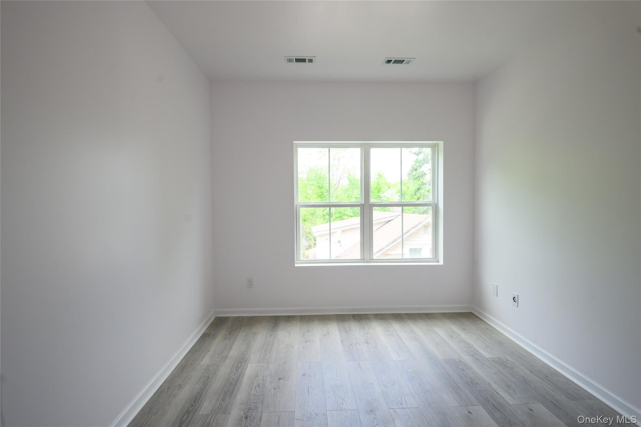 81 Silver Lake Sctn Road Middletown, NY 10940 - Photo 26 of 37 an empty room with wooden floor and windows